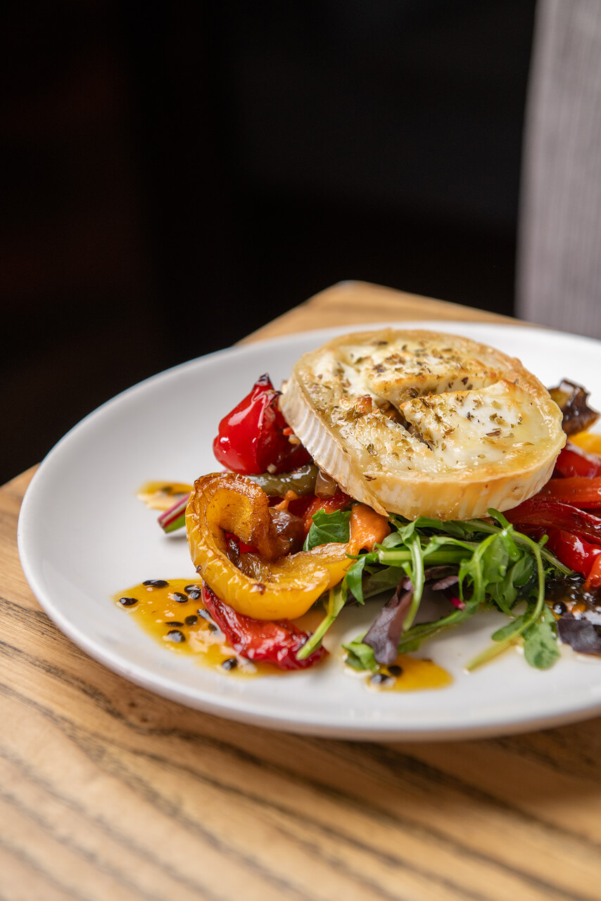 Baked goats cheese, roasted peppers & passionfruit syrup